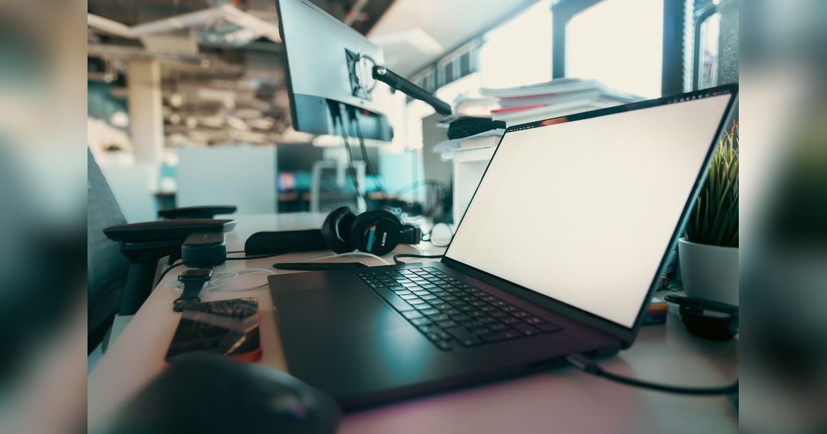 Un ordinateur et un casque sur un bureau.